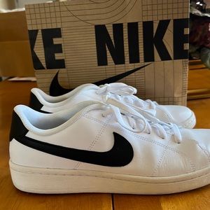 White Nikes with black swoosh